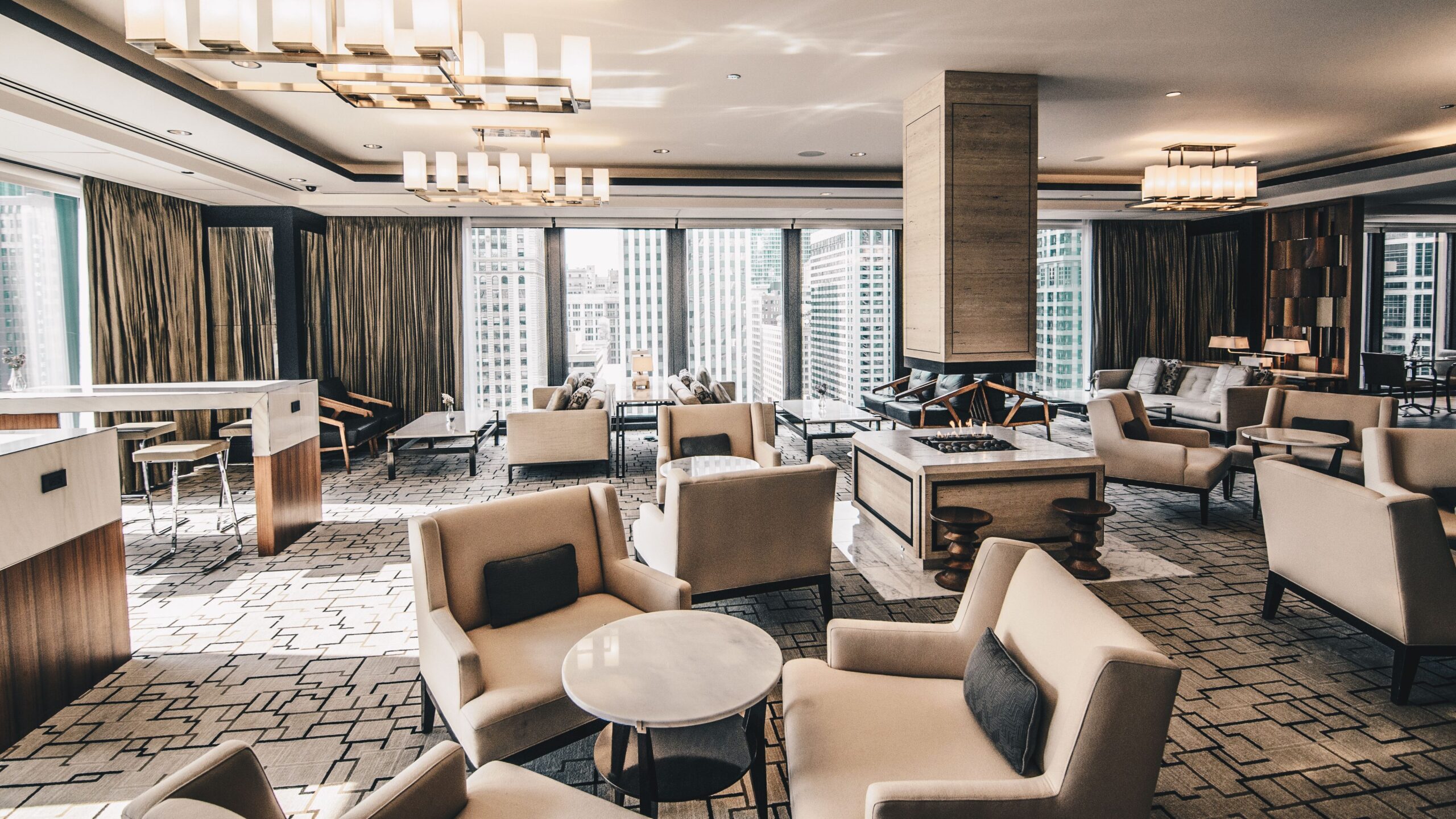 A contemporary hotel lounge in Chicago featuring elegant furniture and large windows.
